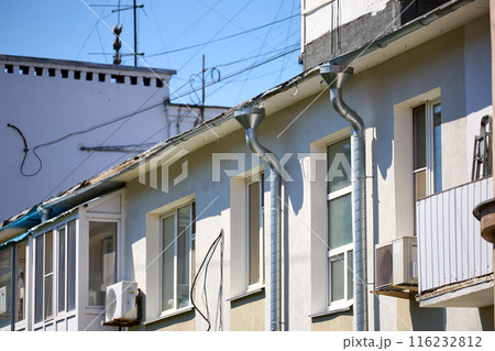 Drain pipe from the roof on the wall of the building 116232812
