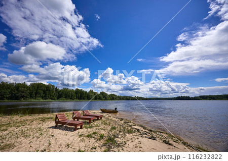 Wooden chairs on the beach of the riverbank Wooden chairs on the beach of the riverbank 116232822