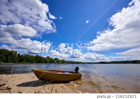 A boat on the riverbank on a sunny day A boat on the riverbank on a sunny day 116232823