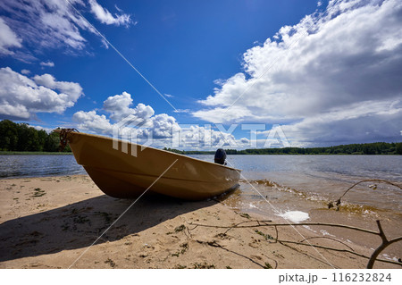 A boat on the riverbank on a sunny day 116232824