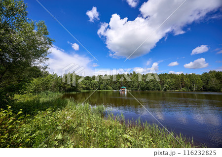 Beautiful summer river at sunny day with clouds reflection in the water Beautiful summer river at sunny day with clouds reflection in the water 116232825