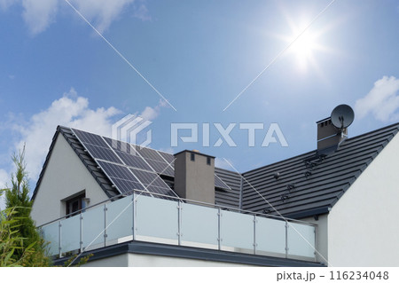 Solar panels installed on a modern house roof under a bright sunny sky. Solar panels installed on a modern house roof under a bright sunny sky. 116234048