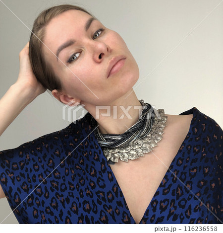 Portrait of a young woman in unusual massive jewelry 116236558