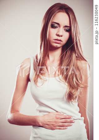 Girl suffering from stomach pain 116238049