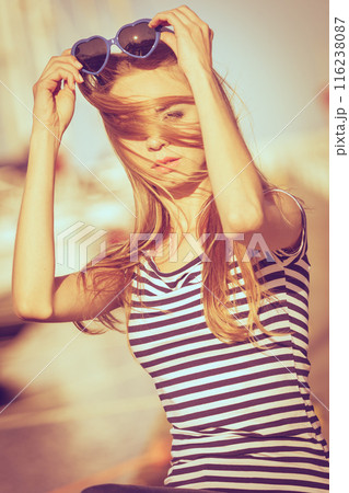 Girl enjoying summer breeze at sunset in marina 116238087