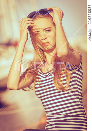 Girl enjoying summer breeze at sunset in marina 116238088