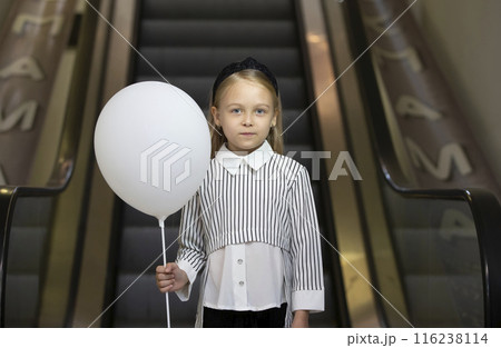A sad little girl with a white air garik stands at the extreme subway. A sad little girl with a white air garik stands at the extreme subway. 116238114