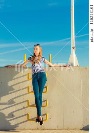 woman casual style against stone wall 116238161