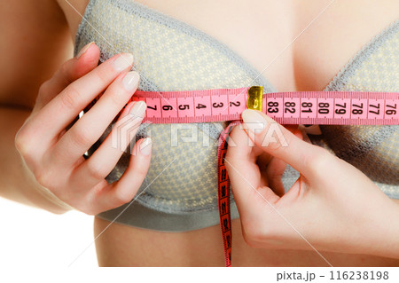 Woman in bra lingerie measuring her chest breasts. Woman in bra lingerie measuring her chest breasts. 116238198