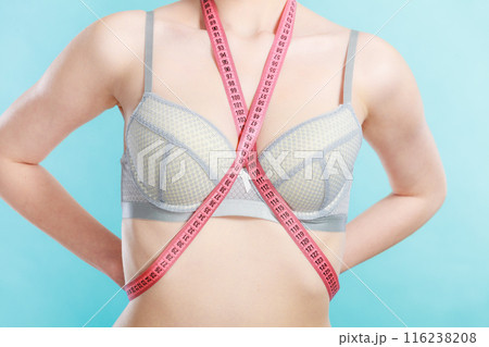 Woman in underwear with measure tape 116238208