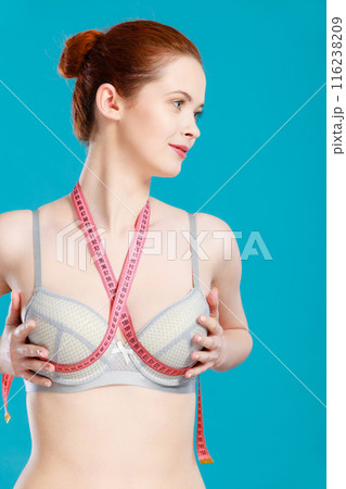 Woman in underwear with measure tape Woman in underwear with measure tape 116238209