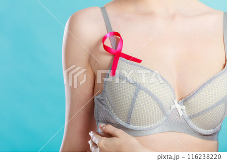 woman in bra with breast cancer awareness ribbon 116238220