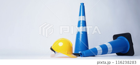 Road traffic safety equipment. Realistic blue traffic cones and yellow safety helmet isolated on white background. Roadside tools for road work or unpredicted automotive accident. Safety first concept Road traffic safety equipment. Realistic blue traffic cones and yellow safety helmet isolated on white background. Roadside tools for road work or unpredicted automotive accident. Safety first concept 116238283