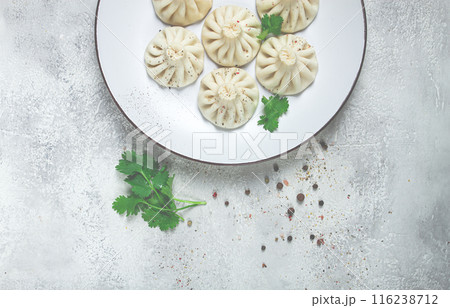 Khinkali, a traditional Georgian dish, with spices and herbs, on a white plate, top view, no people, 116238712