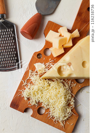 Grated cheese, Maasdam, on a cutting board, grater and cheese knife, close-up, no people, 116238736