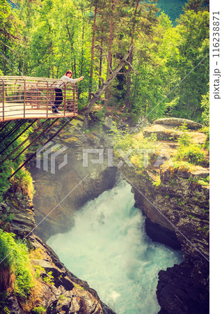 Tourist with camera on Gudbrandsjuvet waterfall, Norway 116238871