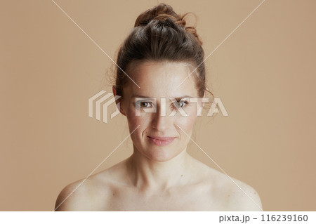 happy young woman isolated on beige 116239160