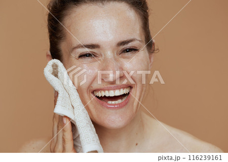 smiling modern female with towel washing face 116239161