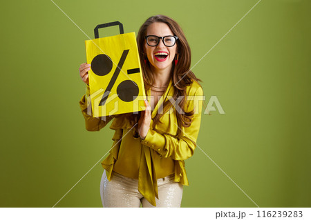 smiling woman in green blouse and glasses isolated on green 116239283