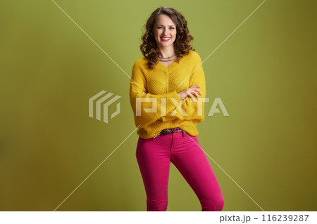 smiling healthy woman against green background 116239287