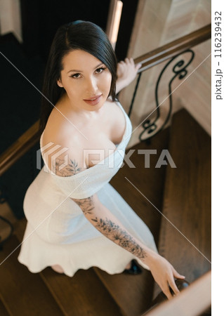 Woman In White Dress Descending Wooden Staircase 116239432