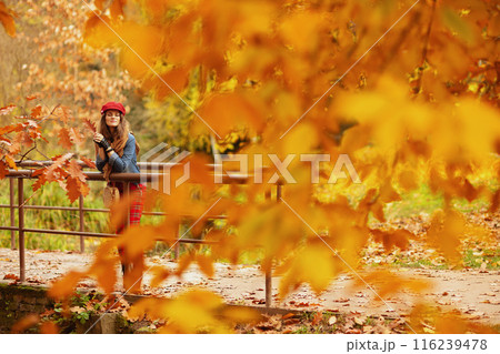 Full length portrait of relaxed woman in jeans shirt and hat Full length portrait of relaxed woman in jeans shirt and hat 116239478