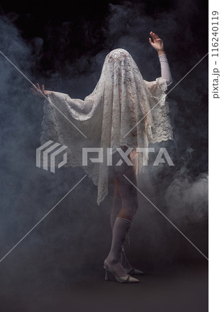 Unrecognizable woman covered in lace veil with raised arms Unrecognizable woman covered in lace veil with raised arms 116240119