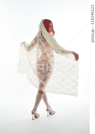 Elegant naked woman covered by lace veil in studio 116240122