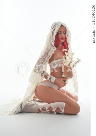 Gentle woman in white underwear and fata with flowers in her hands Gentle woman in white underwear and fata with flowers in her hands 116240126