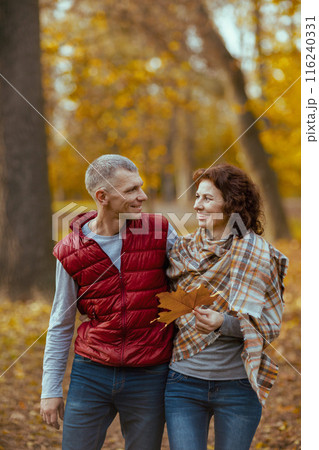 smiling romantic boyfriend and girlfriend in park walking 116240331