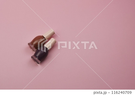 Nail polish small glass bottles on pink background, professional manicure concept 116240709