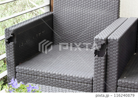 Old wicker balcony furniture with holes. Furniture for the terrace. Background. Texture. Horizontal 116240879