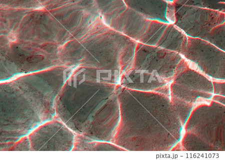 Sun glare on the water in the fountain with an old stone floor, unusual abstract texture 116241073