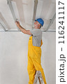 Senior adult worker fixing aluminum batten for gypsum ceiling Senior adult worker fixing aluminum batten for gypsum ceiling 116241117
