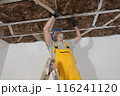 Senior adult worker apply insulation for gypsum ceiling Senior adult worker apply insulation for gypsum ceiling 116241120