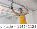 Senior adult worker fixing aluminum batten for gypsum ceiling Senior adult worker fixing aluminum batten for gypsum ceiling 116241124