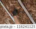 Worker hand in glove apply insulation for gypsum ceiling Worker hand in glove apply insulation for gypsum ceiling 116241125