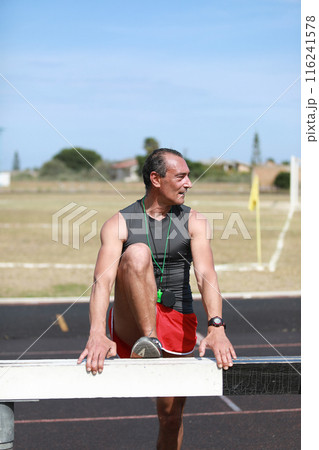 Athlete Recovering Legs On Small Wall Athlete Recovering Legs On Small Wall 116241578