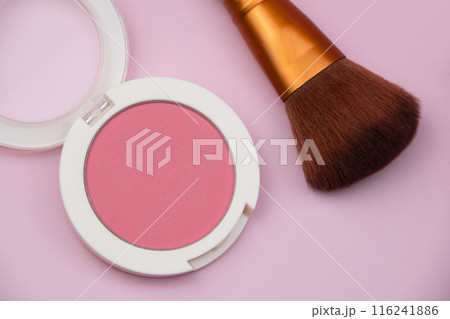 Coral blush, fuchsia eyeshadows and makeup brush on pink background, cosmetics texture Coral blush, fuchsia eyeshadows and makeup brush on pink background, cosmetics texture 116241886
