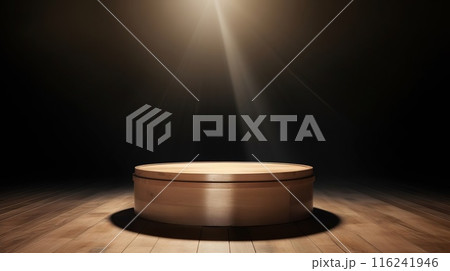 Round wooden podium, wooden pedestal for an object, on a dark, black background with bokeh. Photo 116241946