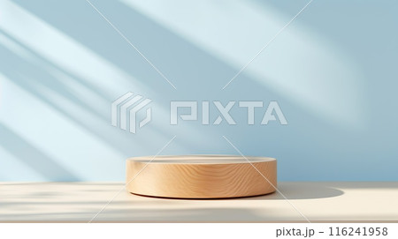 Beautiful round wooden podium, pedestal for an object against a background of a blue sunny wall.  116241958