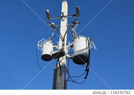 Power transformers on a pole to power the building 116242782