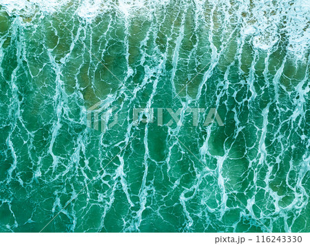 Overhead view turquoise stormy ocean waves with white foam in the ocean,Sea water with splashes and foam, Top view waves background, Natural background photo sea texture with waves soft focus 116243330