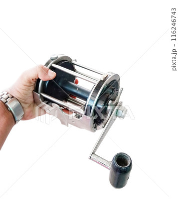 Man holding a large sea fishing reel on a white background 116246743