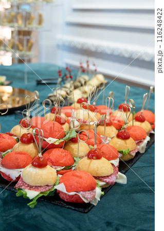 Mini Small burgers served on one plate as appetizers . Mini Small burgers served on one plate as appetizers . 116248422