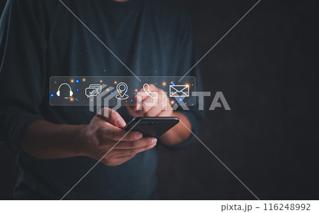 Person using smartphone with communication icons overlay, business marketing online contact us support, and customer service. digital technology help client internet 116248992