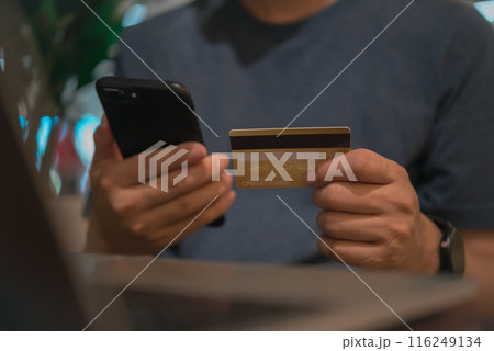 Man holding credit card and smartphone for online shopping, digital payment concept. cellphone app check balance client banking customer transaction Man holding credit card and smartphone for online shopping, digital payment concept. cellphone app check balance client banking customer transaction 116249134