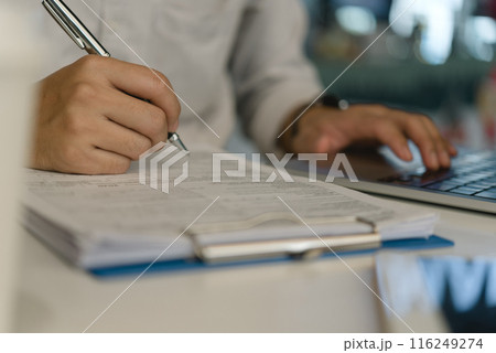 Business person Writing contract law and paper work for business and finance, write document, complete job application forms, contract real estate and insurance concept. 116249274
