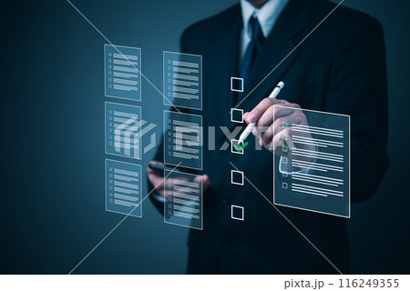 Business executive using a stylus to complete a checklist on a futuristic interface. 116249355