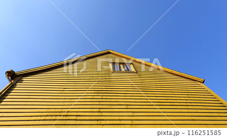 yellow textured wall horizontal with blue sky 116251585